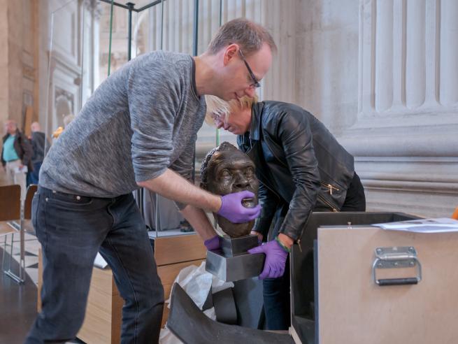 history and collections team loading bust onto plinth 