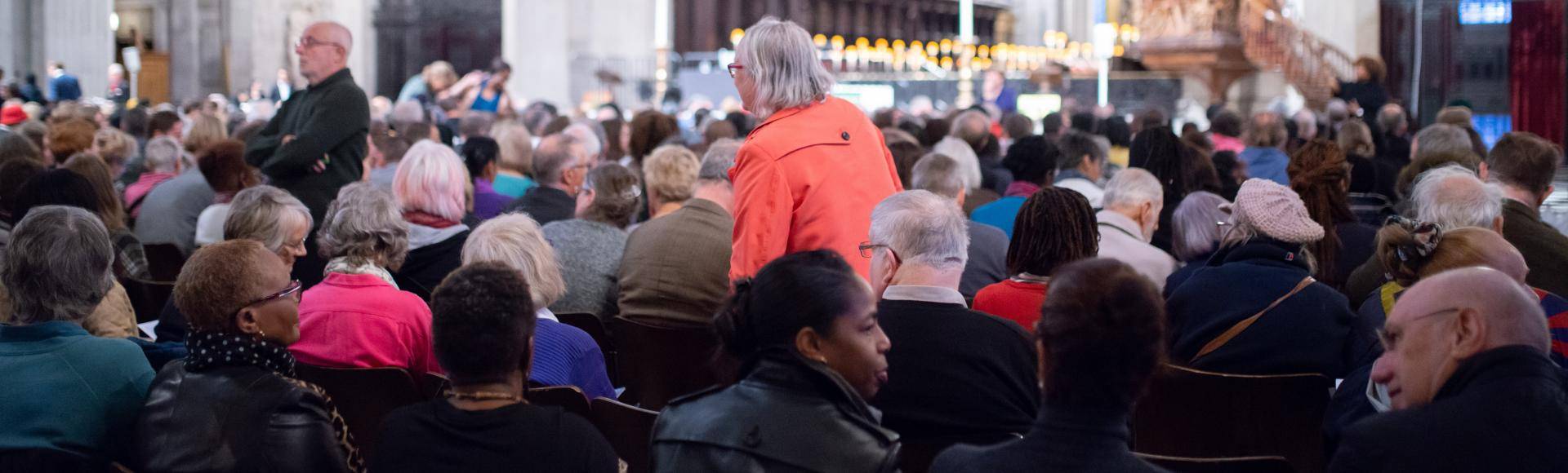 Audience members take their seats at an event at the cathedral