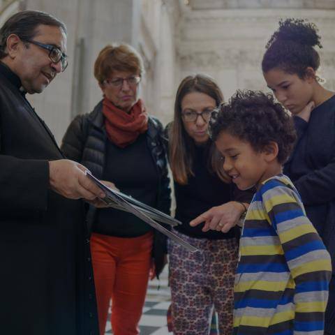 family looking at a map inside cathedral