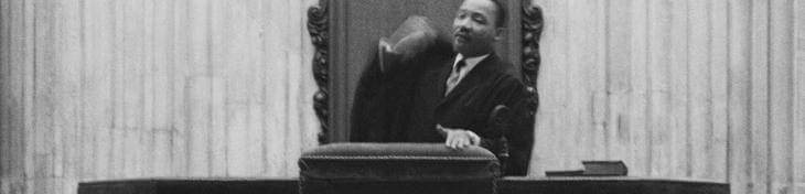 A black and white image of Martin Luther King standing in the pulpit at St Paul's