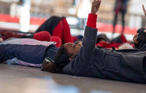 schools child lying down pointing