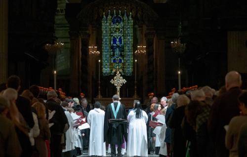 Service dark congregation nave crucifix