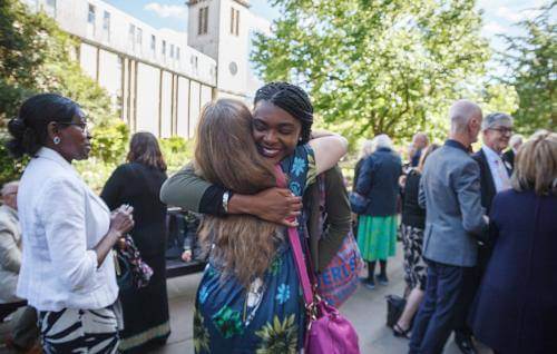 volunteer freinds hug sun churchyard