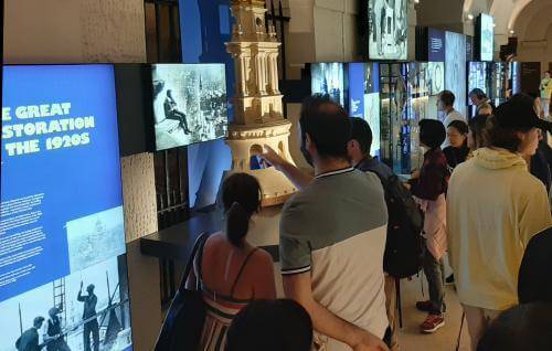 People viewing the Great Restoration exhibition in the Crypt