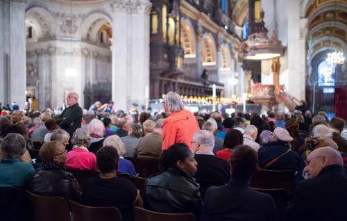 Audience members take their seats at an event at the cathedral