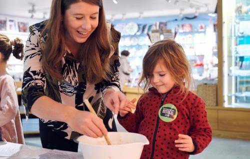 An adult and child take part in craft activities together