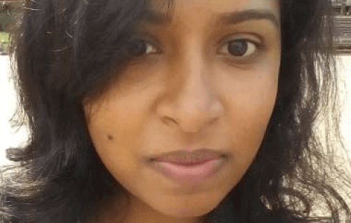 A headshot of Anupama who is a young Asian woman with long dark hair 