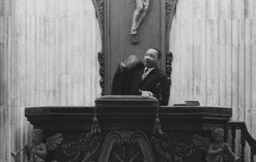 A black and white image of Martin Luther King standing in the pulpit at St Paul's