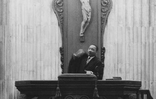 A black and white image of Martin Luther King standing in the pulpit at St Paul's