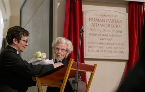 A photo of a new plaque being unveiled in the Crypt of St Paul's Cathedral, with two women standing in front.